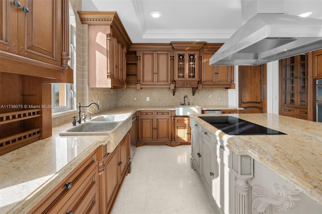 kitchen featuring black electric stovetop, island range hood, light stone counters, and decorative backsplash