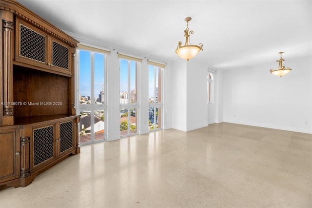 unfurnished room with expansive windows