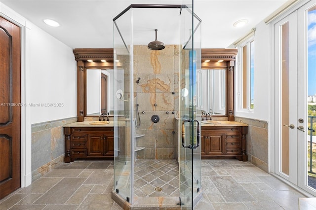 bathroom featuring vanity, an enclosed shower, and tile walls