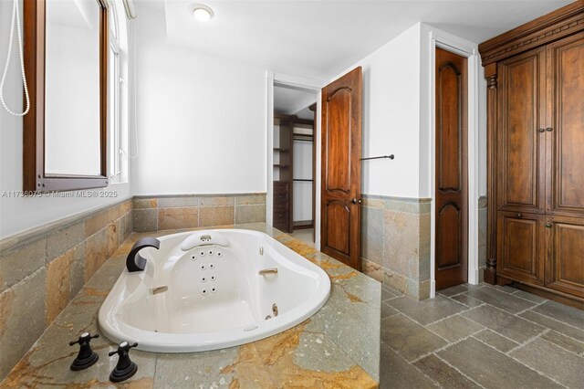 bathroom featuring vanity and tile walls