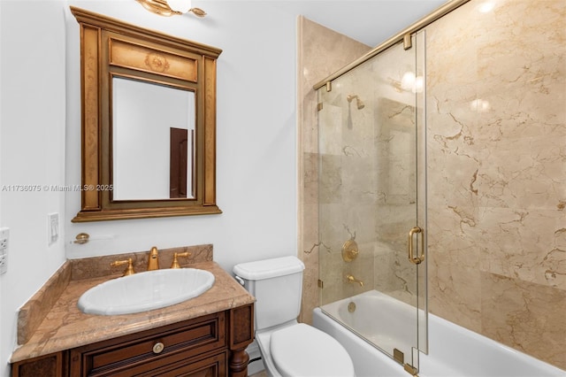 full bathroom with vanity, combined bath / shower with glass door, and toilet