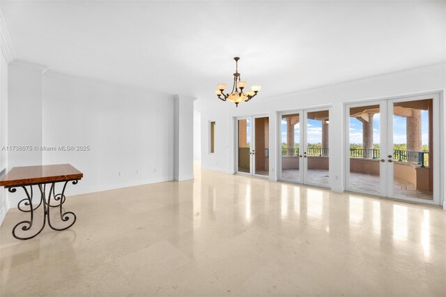 unfurnished room featuring french doors, ornamental molding, and an inviting chandelier