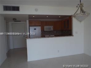 kitchen featuring white appliances and kitchen peninsula