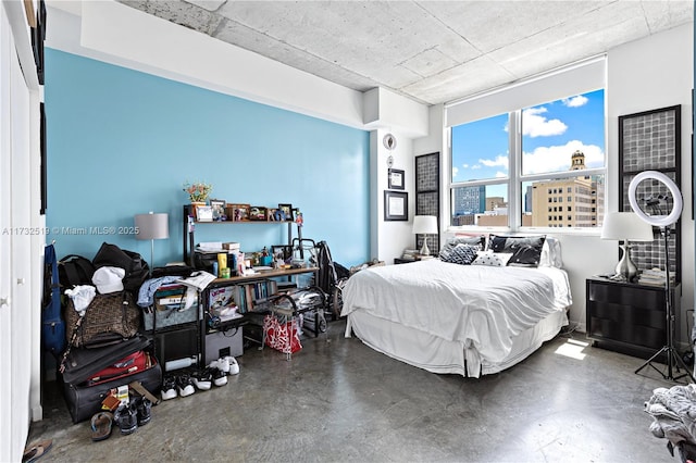 bedroom featuring concrete floors