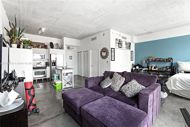 living room featuring concrete flooring