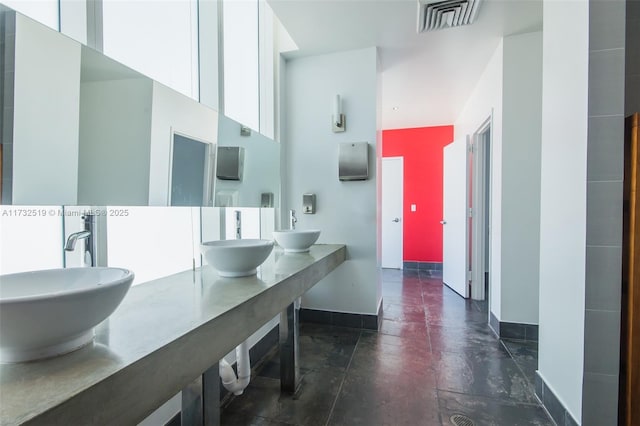 bathroom with a towering ceiling and vanity