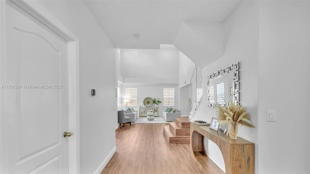 corridor featuring baseboards and wood finished floors