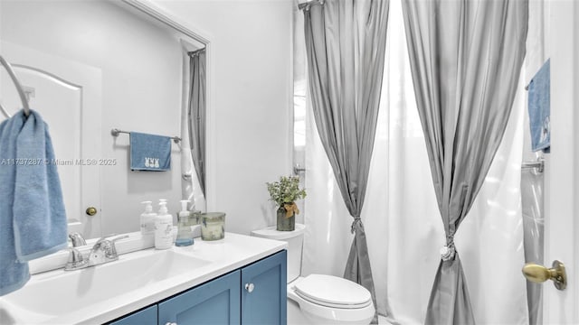 bathroom featuring toilet and vanity