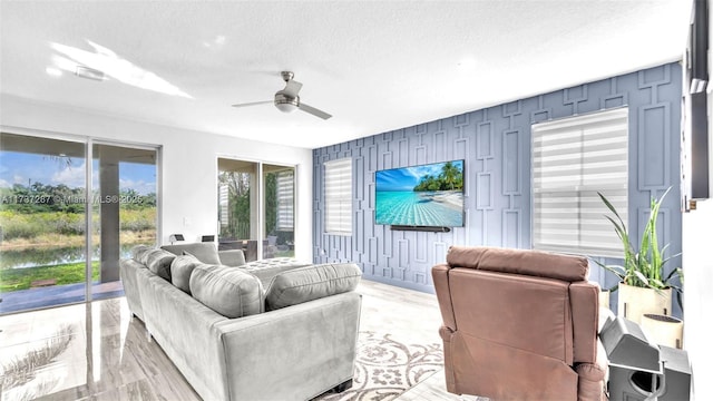 interior space with ceiling fan and a textured ceiling