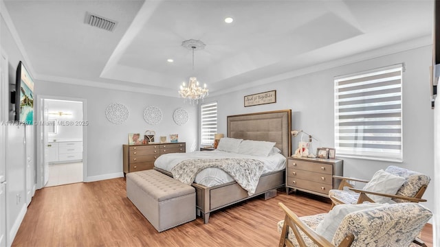 bedroom featuring light wood-type flooring, visible vents, a raised ceiling, and a chandelier