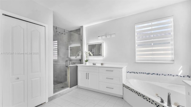 bathroom with a jetted tub, a shower stall, and vanity