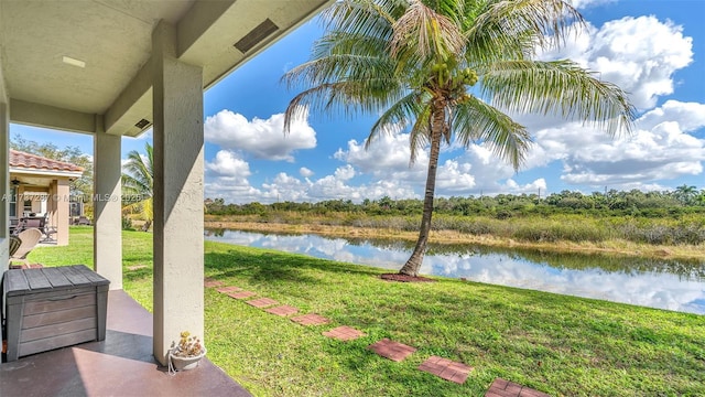 view of yard featuring a patio area and a water view