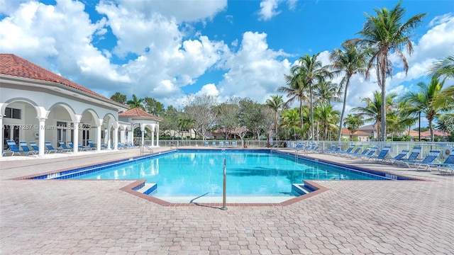 community pool featuring a patio and fence