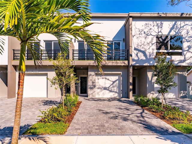 view of front facade featuring a balcony and a garage