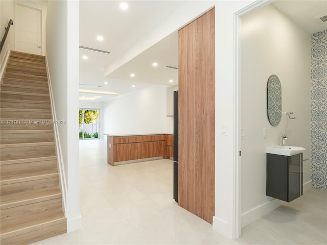 hall featuring sink and a barn door