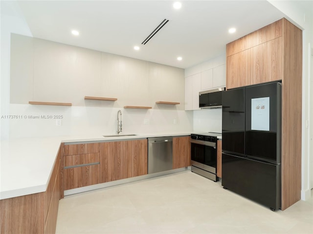 kitchen featuring white cabinetry, sink, and appliances with stainless steel finishes