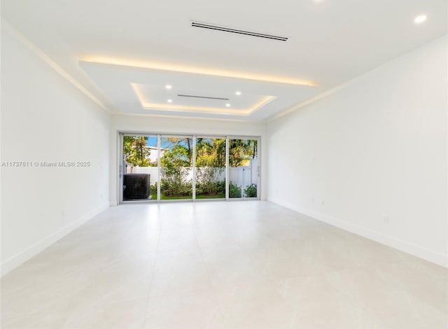 unfurnished room featuring a raised ceiling