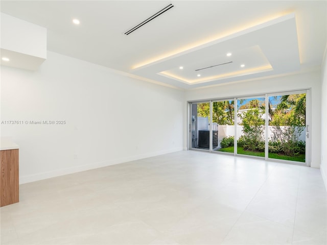 unfurnished room featuring a raised ceiling