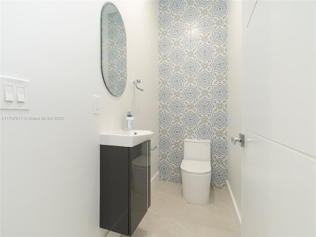 bathroom featuring vanity, tile patterned flooring, and toilet