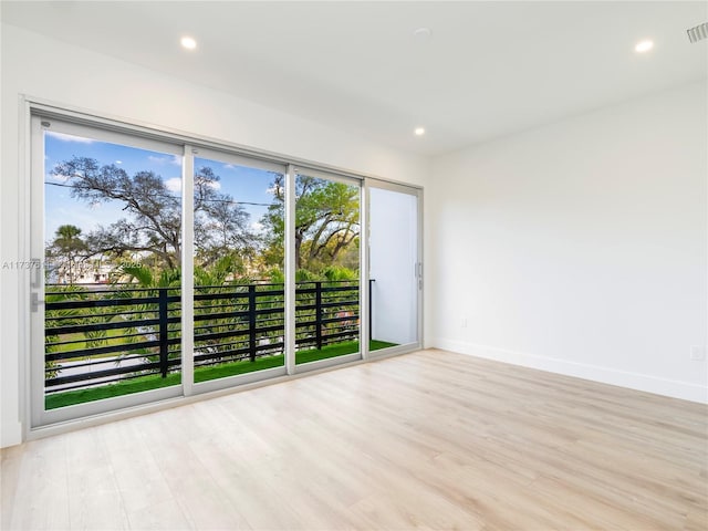 spare room with light wood-type flooring