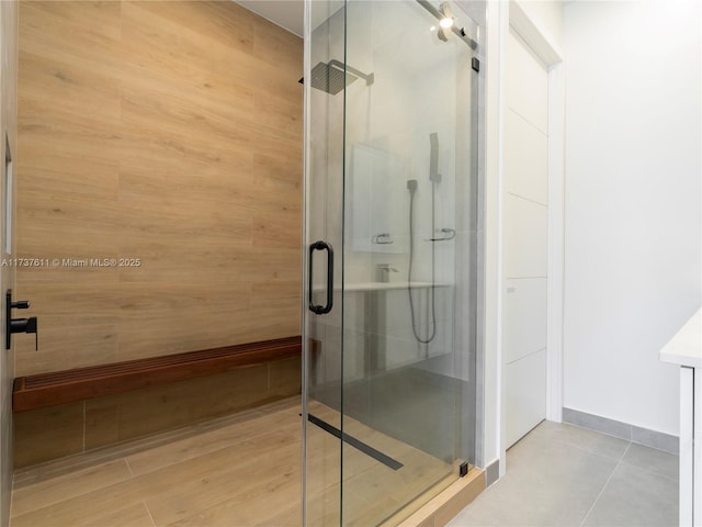 bathroom featuring a shower with shower door