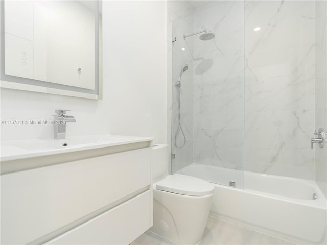 full bathroom featuring vanity, toilet, and tiled shower / bath combo