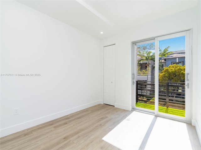 unfurnished room with light wood-type flooring