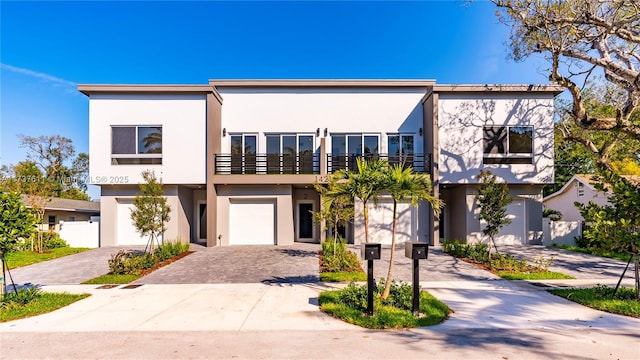 view of front facade with a balcony and a garage