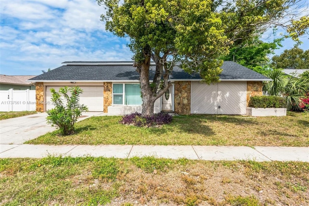 view of front of home featuring a garage and a front lawn