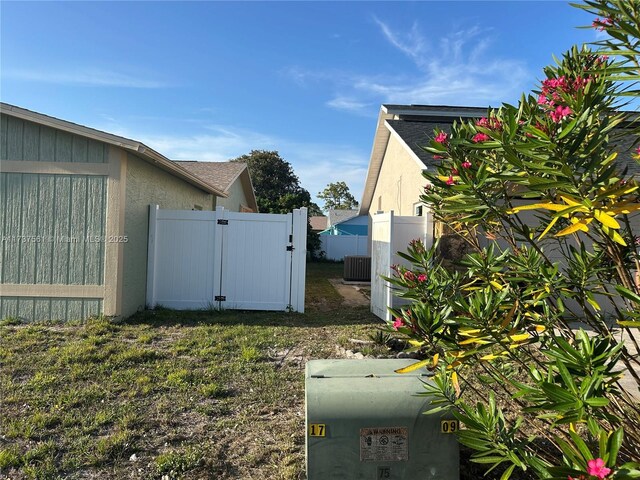 7403 Foxbloom Dr, New Port Richey, FL 34668 - view of yard featuring central air condition unit and a gate