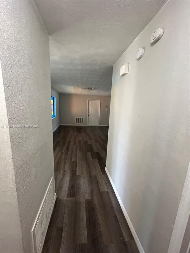 7403 Foxbloom Dr, New Port Richey, FL 34668 - corridor featuring wood finished floors and baseboards