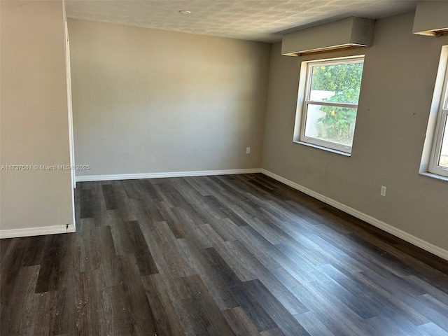 7403 Foxbloom Dr, New Port Richey, FL 34668 - unfurnished room with baseboards and dark wood-type flooring