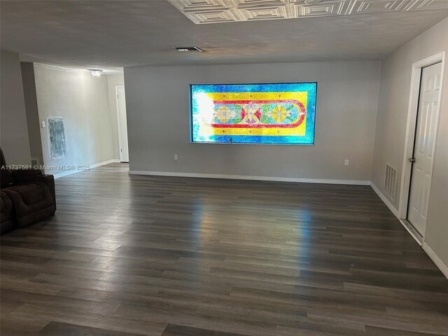 7403 Foxbloom Dr, New Port Richey, FL 34668 - unfurnished living room with baseboards and dark wood-style floors