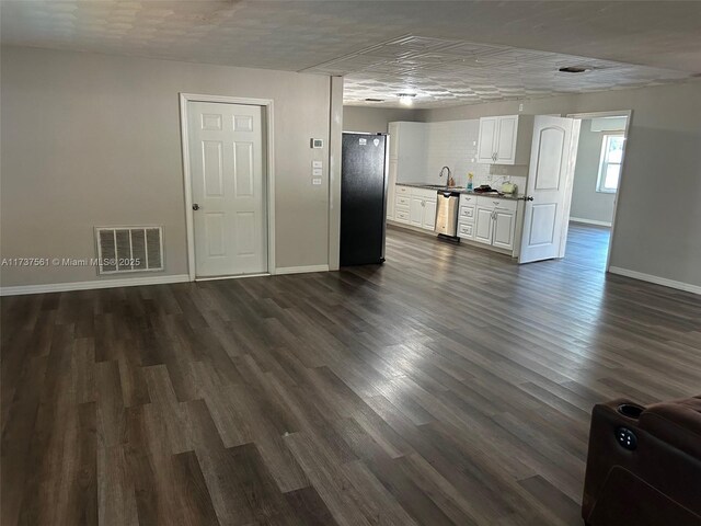 7403 Foxbloom Dr, New Port Richey, FL 34668 - unfurnished living room with baseboards, dark wood finished floors, and a sink