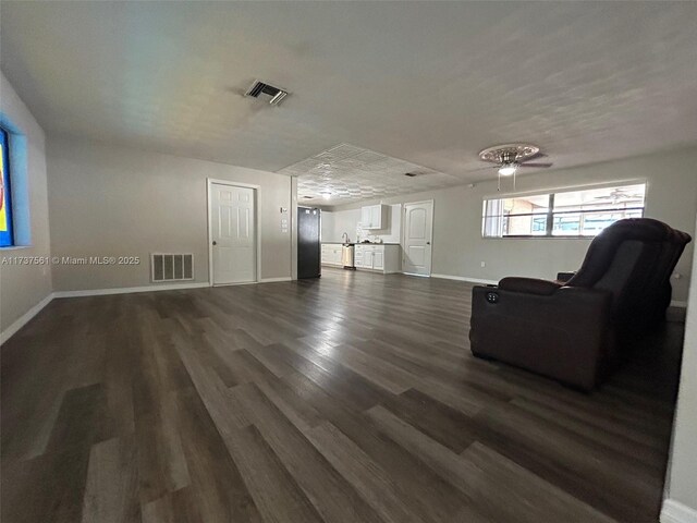 7403 Foxbloom Dr, New Port Richey, FL 34668 - living area with baseboards and dark wood-style floors