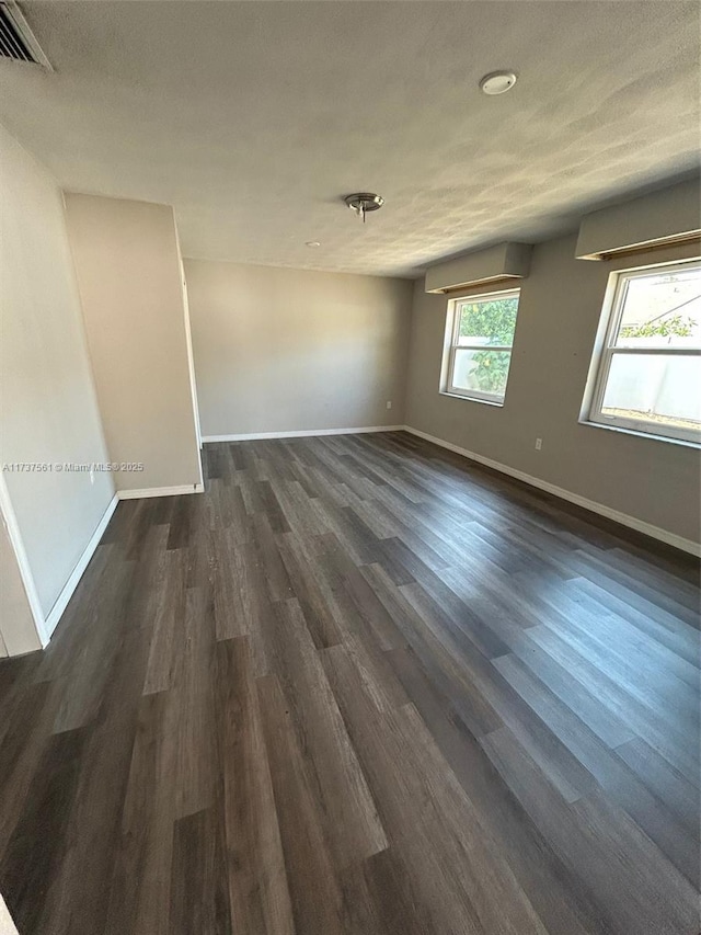 7403 Foxbloom Dr, New Port Richey, FL 34668 - spare room featuring baseboards and dark wood-style floors