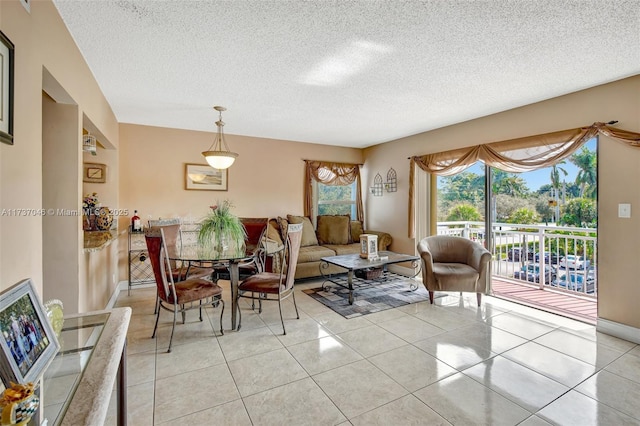 tiled living room featuring a textured ceiling