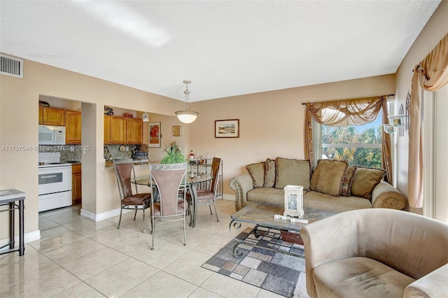 tiled living room with a textured ceiling