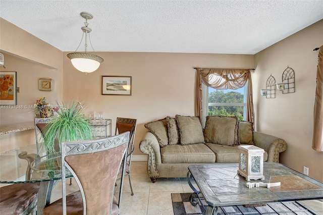 living room featuring a textured ceiling and light tile patterned floors