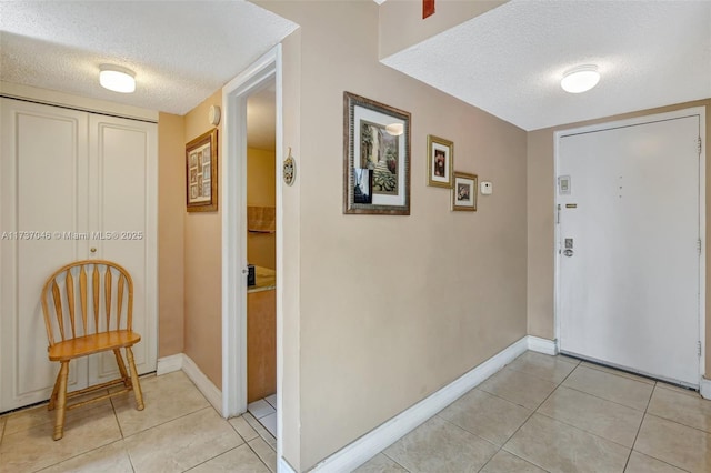 tiled foyer featuring a textured ceiling