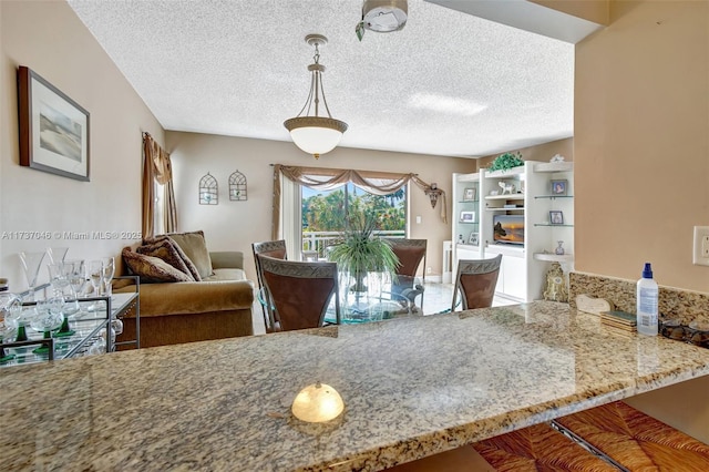 kitchen featuring hanging light fixtures and a textured ceiling