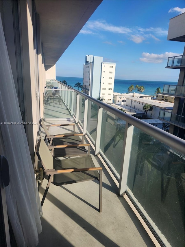 balcony featuring a water view