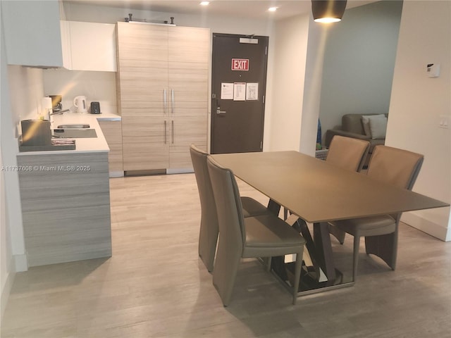 dining space featuring sink and light hardwood / wood-style floors