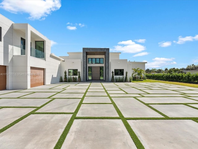 back of house featuring a yard and a garage