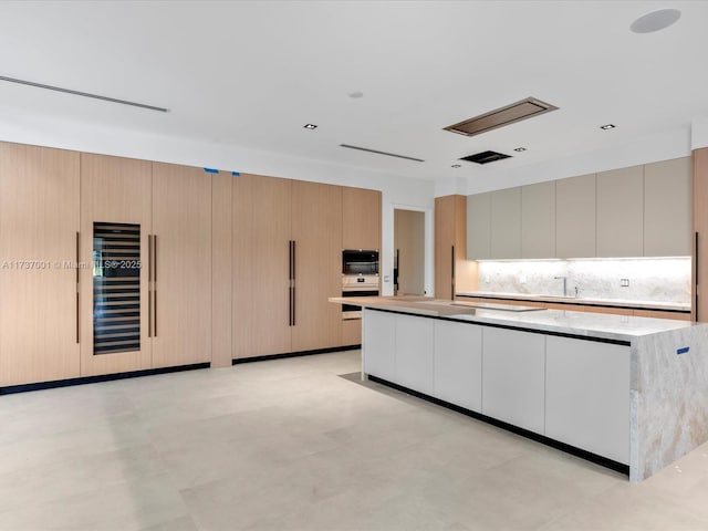 kitchen with tasteful backsplash and a kitchen island