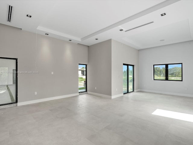 empty room with a raised ceiling and a high ceiling