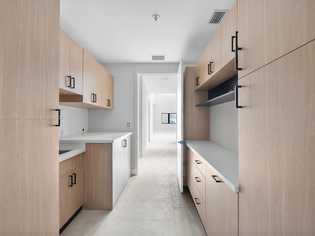 kitchen featuring light brown cabinetry