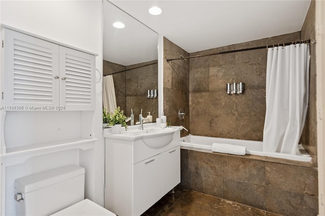 full bathroom featuring vanity, tile walls, shower / bath combination with curtain, and toilet