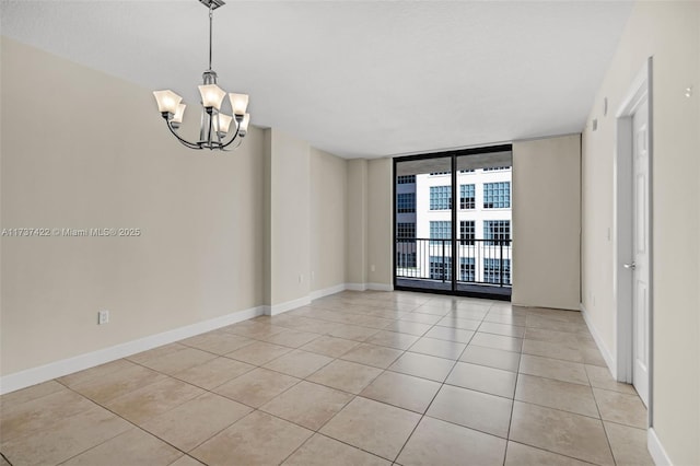 empty room with baseboards, an inviting chandelier, light tile patterned flooring, and floor to ceiling windows