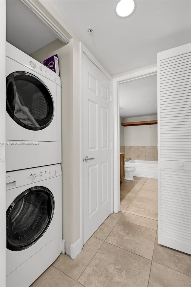 55 Merrick Way Unit 624, Coral Gables, FL 33134 - laundry area featuring estacked washer and dryer and light tile patterned floors